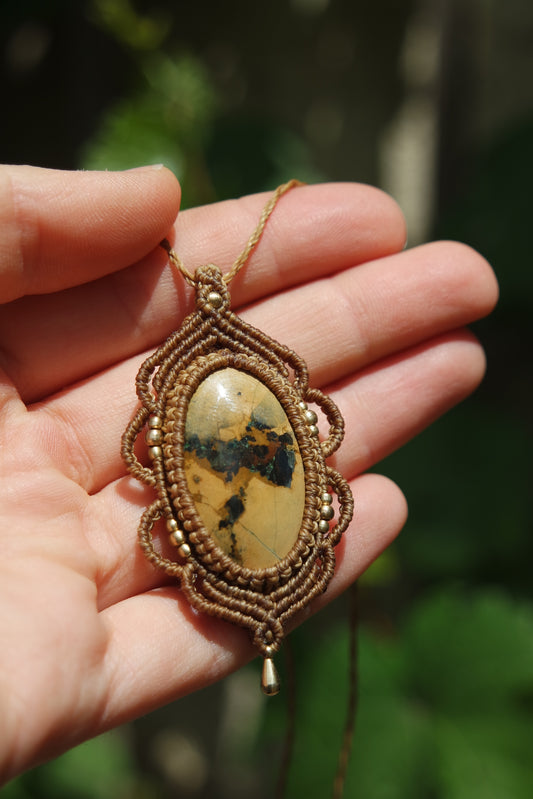 Makramee-Schmuckstück ‚Wächterindestürkis‘ mit natürlichen Farben – in der Hand gehalten, Fokus auf Stein und Perlen